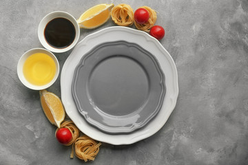 Empty plate with ingredients for dinner on table