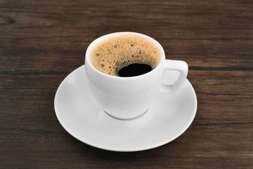Cup of coffee on wooden background