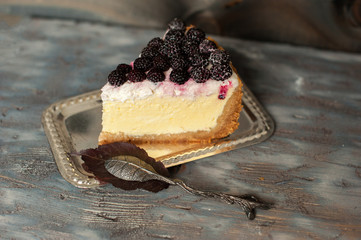 A delicious piece of cake with blackberries