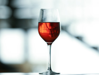 Glass with red wine on table