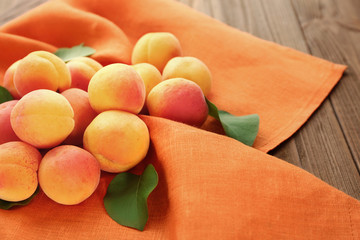 Fresh apricots on orange napkin
