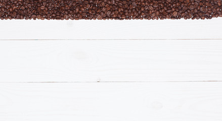 Background white wooden plank with coffee beans