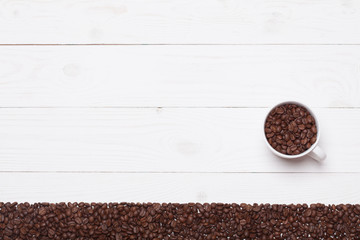 Background white wooden plank with coffee  cup and beans
