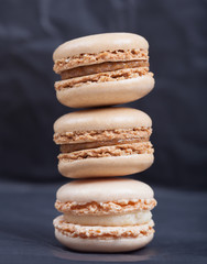 Beautiful delicious cakes with cream macaroon chocolate pistachio nuts vanilla strawberry cherry on dark background