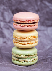 Beautiful delicious cakes with cream macaroon chocolate pistachio nuts vanilla strawberry cherry on dark background