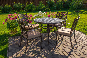 Table and chairs in garden of country house