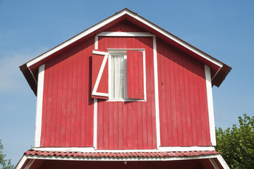 The roof of the red house with nice window.