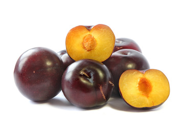 Plum and half of plum on a white background