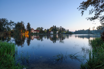 Fototapeta na wymiar Evening landscape with the river and houses on the other bank