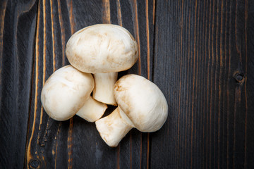 champignon mushroom on wooden background