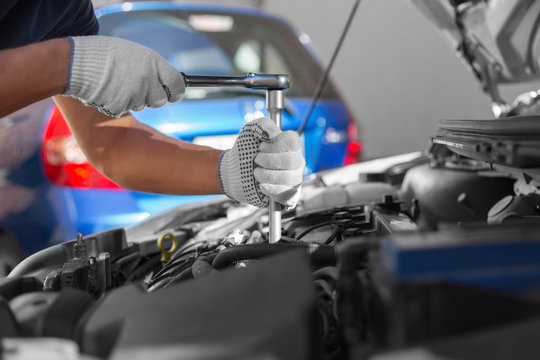 Mechanic working in auto repair garage. Car maintenance