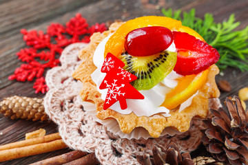 Winter holiday rustic background with fruit tart and spices - cinnamon, anise, peanuts. Christmas...