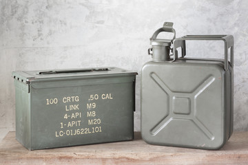 still life photography : old Army green jerrycan ( fuel canister ) and bullet box ( ammo crate ) on...