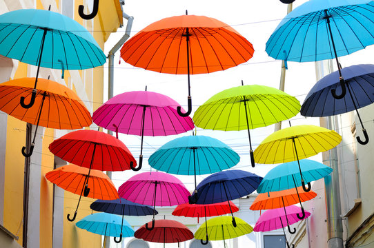 Multicolored umbrellas hanging on strings