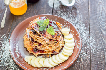 Healthy Pancakes with Banana, Berries and Honey for Breakfast
