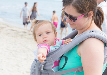 Baby girl in sling,young mother carrying her baby in sling