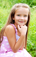 Fototapeta premium Portrait of adorable smiling little girl in summer day