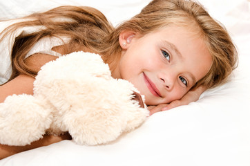 Adorable smiling little girl waked up