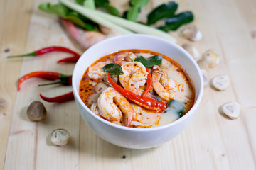 Tom yum kung, and condiment, on wooden table, style blur,  Selec