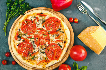 Fresh hot pizza with Parmesan Cheese,bell pepper, parsley and tomatoes