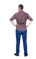 Fototapeta premium Back view of handsome man in shirt looking up. Standing young guy in jeans. Rear view people collection. backside view of person. Isolated over white background.