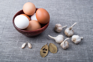 Chicken eggs and garlic and spices on the kitchen table
