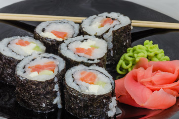 Japanese sushi made with rice, fish and seaweed with ginger and wasabi