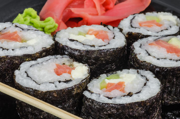Japanese sushi made with rice, fish and seaweed with ginger and wasabi