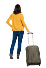 back view of walking  woman  in cardigan with suitcase. beautiful  girl in motion.  backside view of person.  Rear view people collection. Isolated over white background.