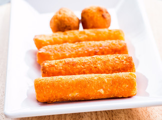 cheese stick and ball on plate