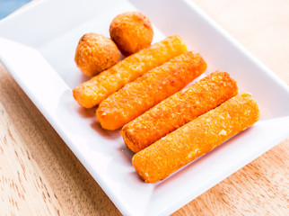 cheese stick and ball on plate