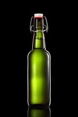 Swing top bottle of light beer isolated on black background