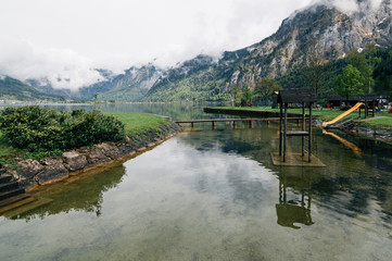 Wooden bridge on Hallstatt Lake a cloudy day after storm