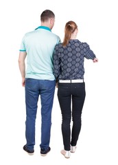 Fototapeta premium young couple pointing. Back view. Rear view people collection. backside view of person. Isolated over white background.