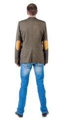 Back view of young business man in jacket  looking ahead of yourself.   Standing  handsome guy in jeans and suit jacket. Rear view people collection.  backside view of person. Isolated over white