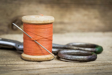 still life of spools of thread on a wooden background