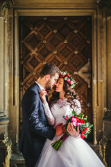 Groom and bride near the doors