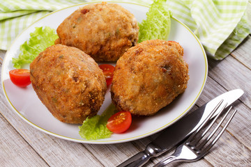 Scotch Eggs Served with Tomato Cherry and Salad on White Plate