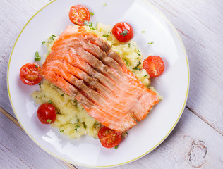 Salmon, Tomato and Smashed Potato with  Spring Onion and Coriander. View from above, top studio shot