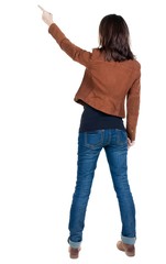 Back view of  pointing woman. beautiful brunette  girl in brown jacket. Rear view people collection.  backside view of person.  Isolated over white background.