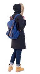Back view woman in winter jacket with a backpack  looking up.   Standing young girl in parka. Rear view people collection.  backside view of person.  Isolated over white background. © ghoststone