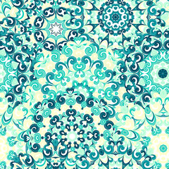 Seamless colorful ethnic pattern with mandalas in oriental style. Round doilies with blue, yellow, green curls and swirls weaving in arabesque traditional lace ornament. Vector illustration.