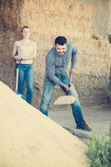 man and woman shovel