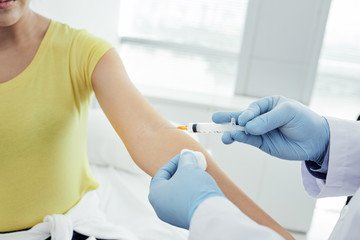 Young woman receiving medication injection in hospital