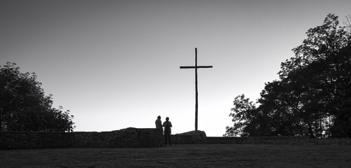 Christian cross backlight. Black and white photo