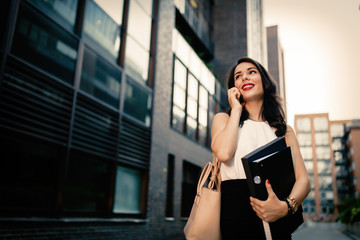 Businesswoman carrying folders