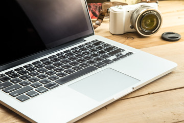 laptop with digital camera on wood background, digital photographer working picture process concept.