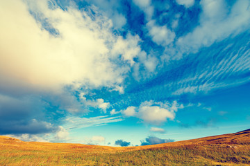Amazing cloudscape above the mountain meadow.