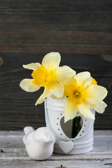 Spring flowers in vase on wooden table