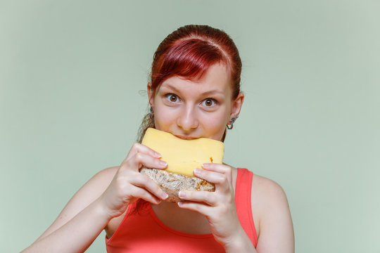 girl bites cheddar cheese